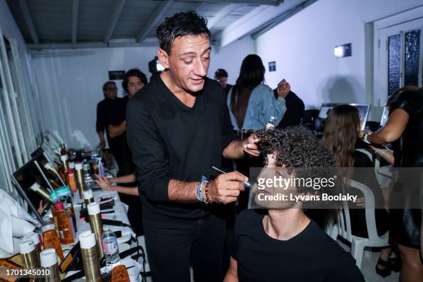 Claverie Benoit and a model prepare backstage prior to the Mossi Womenswear Spring/Summer 2024 show as part of Paris Fashion Week on September 25,...