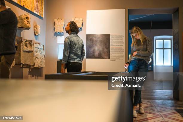 couple of tourists visiting a city museum - looking to the past stock pictures, royalty-free photos & images