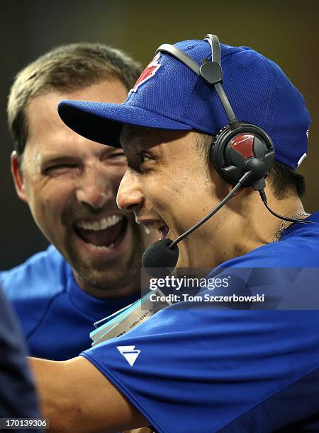 Munenori Kawasaki of the Toronto Blue Jays gets a reaction from teammate Mark DeRosa while doing an interview before an MLB game against the Texas...