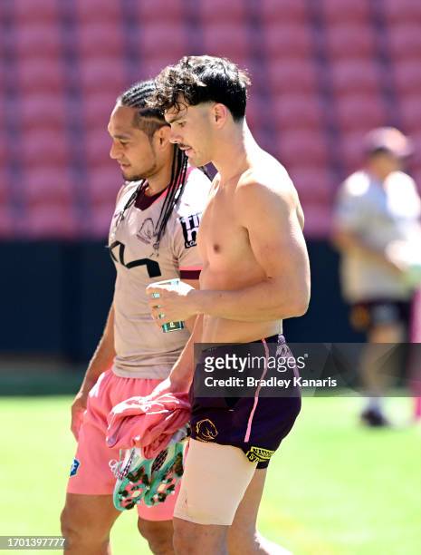 Herbie Farnworth is seen with strapping on his left leg as he chats with team mate Martin Taupau during a Brisbane Broncos NRL training session at...