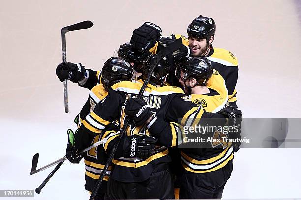 Adam McQuaid of the Boston Bruins celebrates with teammates after scoring a goal in the third period against the Pittsburgh Penguins in Game Four of...