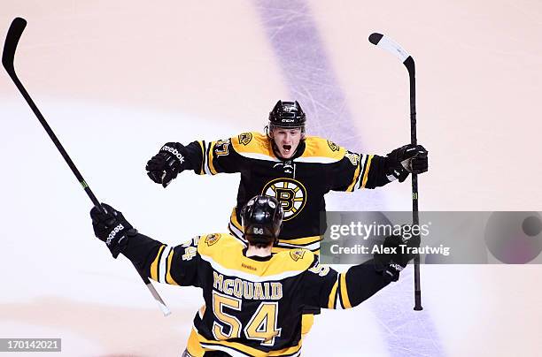 Torey Krug and Adam McQuaid of the Boston Bruins celebrate after McQuaid scores in the third period against the Pittsburgh Penguins in Game Four of...