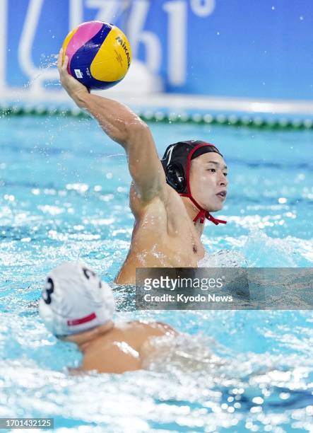 Kiyomu Date of Japan scores a goal against Singapore during the fourth period of their opening men's preliminary-round water polo match at the Asian...