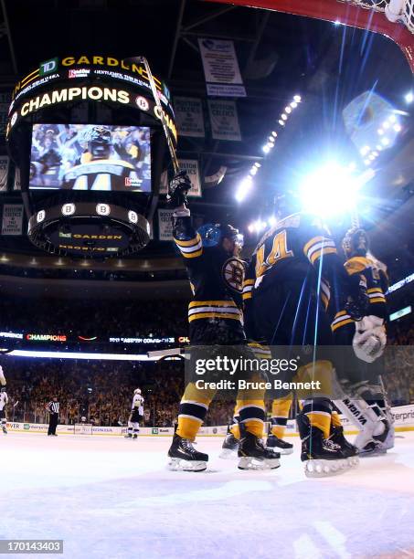 Dennis Seidenberg and Tuukka Rask of the Boston Bruins celebrate with teammates after defeating the Pittsburgh Penguins 1-0 in Game Four of the...