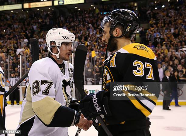 Sidney Crosby of the Pittsburgh Penguins shakes hands with Patrice Bergeron of the Boston Bruins after the Bruins defeated the Penguins 1-0 in Game...