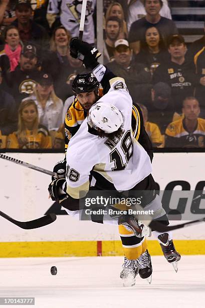 Zdeno Chara of the Boston Bruins knocks over James Neal of the Pittsburgh Penguins in the third period in Game Four of the Eastern Conference Final...