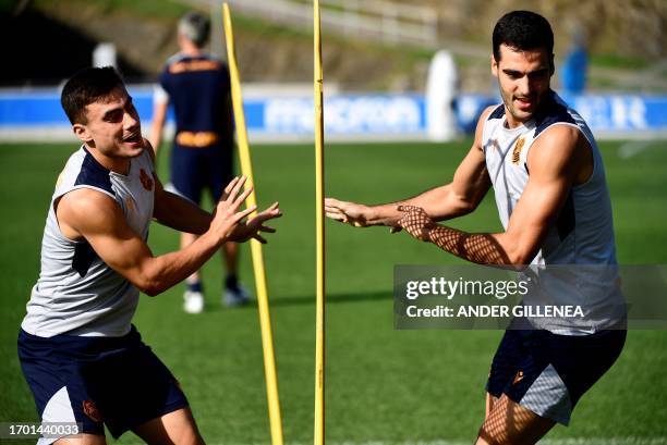 Real Sociedad's Spanish forward Ander Barrenetxea and Real Sociedad's Spanish midfielder Mikel Merino attend a training session ahead of the UEFA...