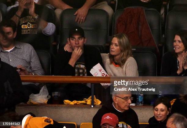 Actors John Krasinski and Emily Blunt sit in the stands during Game Four of the Eastern Conference Final between the Pittsburgh Penguins and Boston...