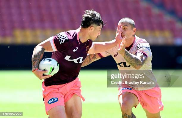 Kotoni Staggs pushes away from the defence during a Brisbane Broncos NRL training session at Suncorp Stadium on September 26, 2023 in Brisbane,...