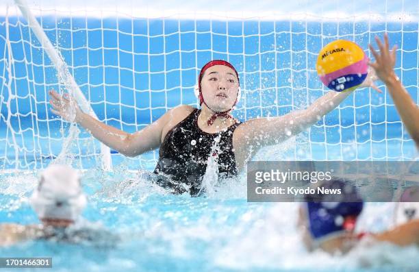 Japan goalkeeper Minami Shioya extends her arm to make a save during their final women's water polo round-robin match against China at the Asian...