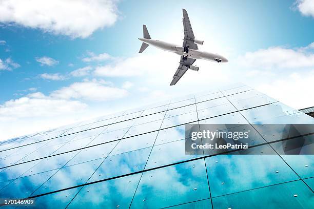 airplane above city financial district - central terminal stock pictures, royalty-free photos & images