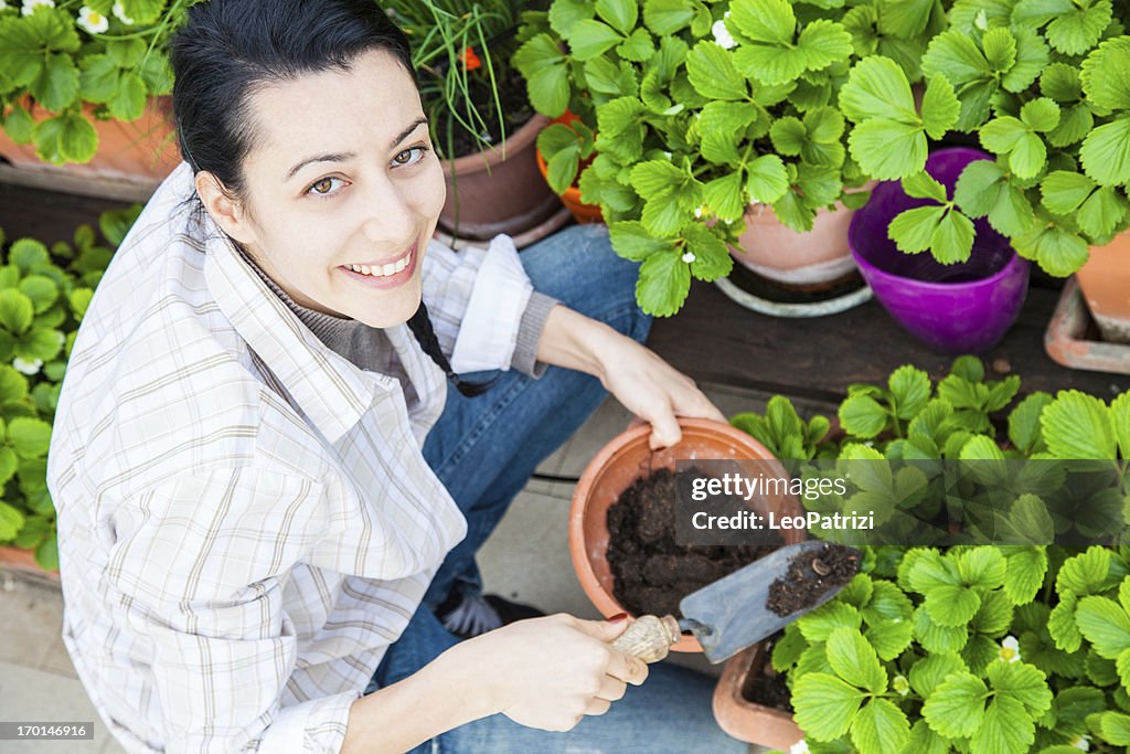 Happy young female gardener on his roof garden