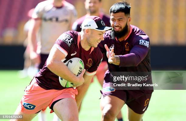 Billy Walters breaks away from the defence of team mate Payne Haas during a Brisbane Broncos NRL training session at Suncorp Stadium on September 26,...