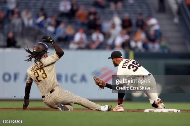 Fernando Tatis Jr. #23 of the San Diego Padres is doubled off at second base by Thairo Estrada of the San Francisco Giants after a fly out in the...