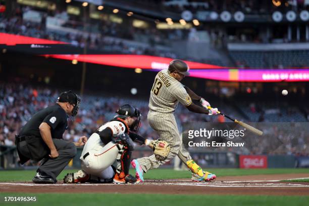 Manny Machado of the San Diego Padres hits a single that scored a run against the San Francisco Giants in the first inning at Oracle Park on...