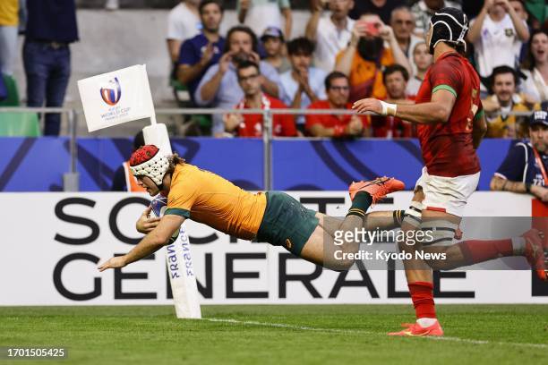 Fraser McReight of Australia scores a try during the second half of a Rugby World Cup Pool C match against Portugal at Stade Geoffroy-Guichard in...