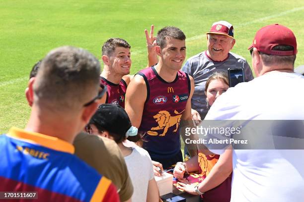 Dayne Zorko and Brandon Starcevich of the Lions interact with fans during a Brisbane Lions AFL training session at Brighton Homes Arena on September...