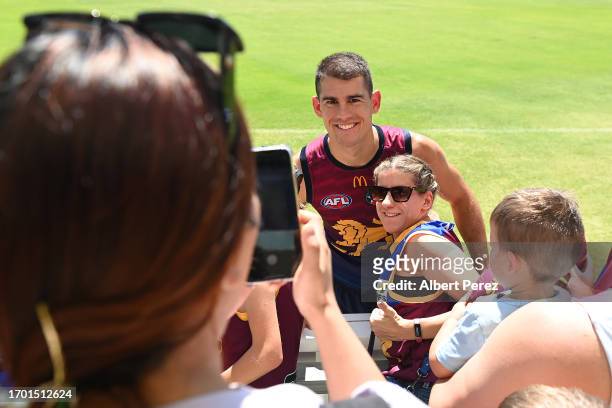 Brandon Starcevich of the Lions interacts with fans during a Brisbane Lions AFL training session at Brighton Homes Arena on September 26, 2023 in...