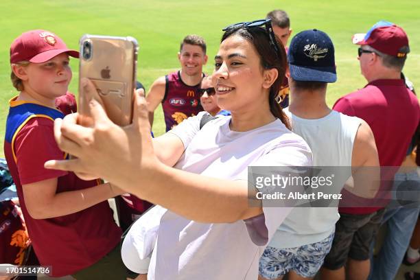 Fans take selfies with players during a Brisbane Lions AFL training session at Brighton Homes Arena on September 26, 2023 in Ipswich, Australia.