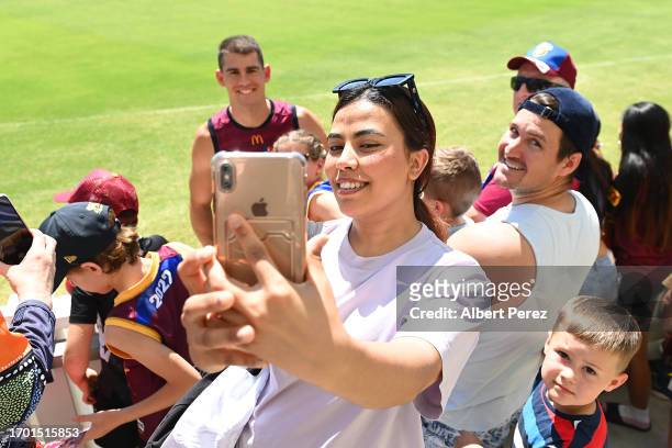 Fans take selfies with players during a Brisbane Lions AFL training session at Brighton Homes Arena on September 26, 2023 in Ipswich, Australia.