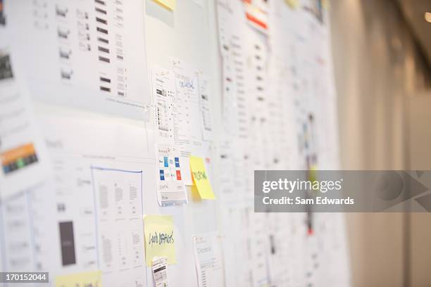 documents and adhesive notes on wall in office - white board stock pictures, royalty-free photos & images