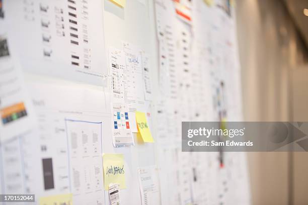 documents and adhesive notes on wall in office - whiteboard bildbanksfoton och bilder