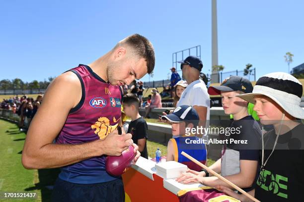 Darcy Wilmot of the Lions signs autographs during a Brisbane Lions AFL training session at Brighton Homes Arena on September 26, 2023 in Ipswich,...