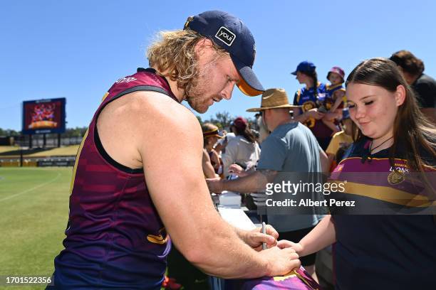 Daniel Rich of the Lions signs autographs during a Brisbane Lions AFL training session at Brighton Homes Arena on September 26, 2023 in Ipswich,...