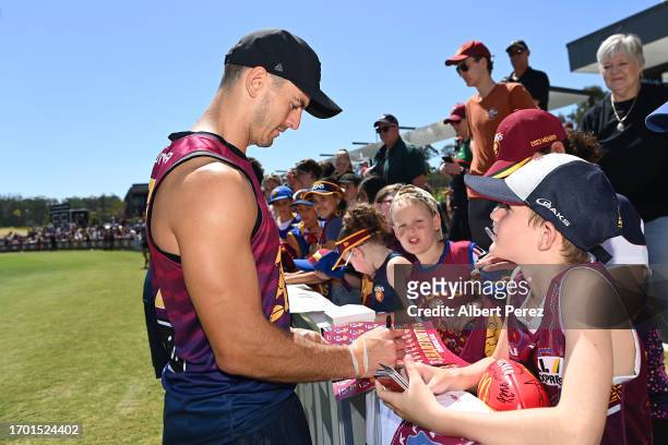 Jarryd Lyons of the Lions signs autographs during a Brisbane Lions AFL training session at Brighton Homes Arena on September 26, 2023 in Ipswich,...