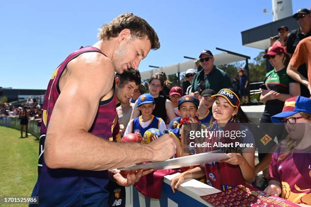 Harris Andrews of the Lions signs autographs during a Brisbane Lions AFL training session at Brighton Homes Arena on September 26, 2023 in Ipswich,...