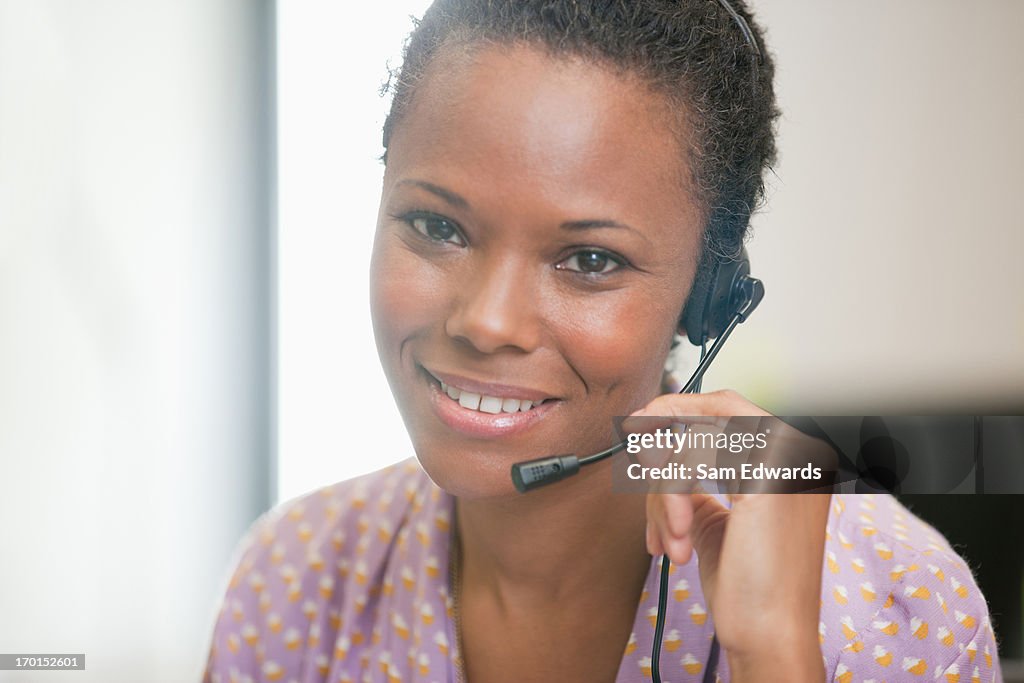 Close up portrait of smiling businesswoman with headset