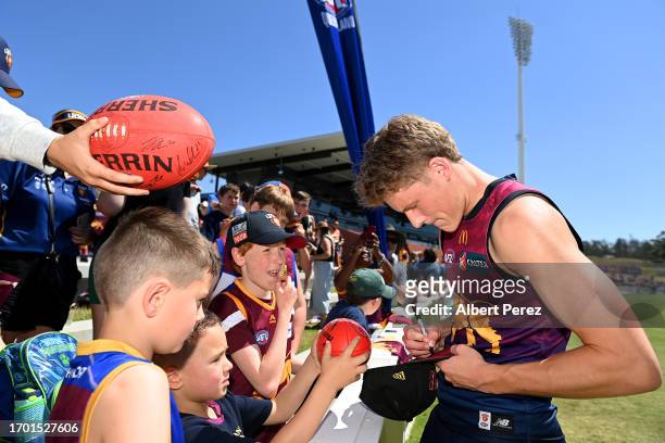 Jaspa Fletcher of the Lions signs autographs during a Brisbane Lions AFL training session at Brighton Homes Arena on September 26, 2023 in Ipswich,...