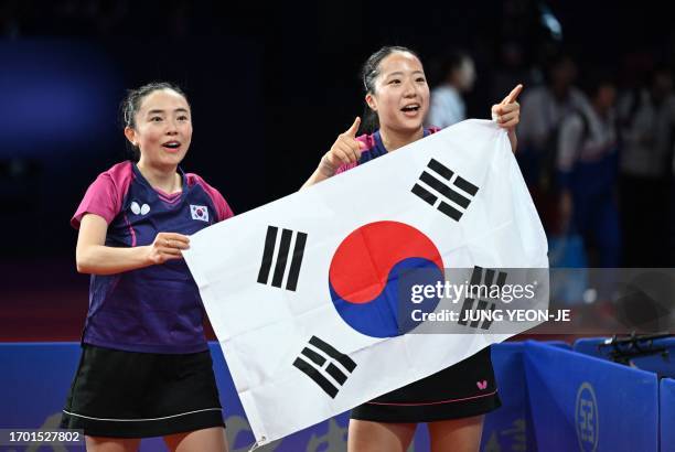 South Korea's Jeon Ji-hee and Shin Yu-bin celebrate their victory after defeating North Korea's Cha Su Yong and Pak Su Gyong in the women's doubles...