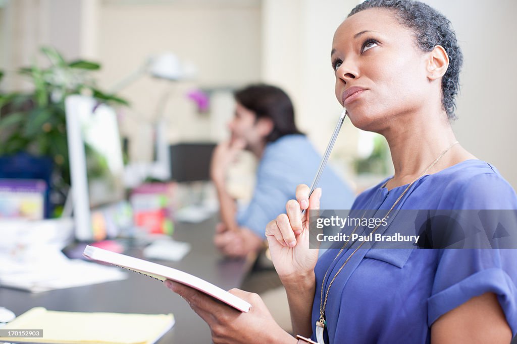 Close up of smiling businesswoman looking up in office