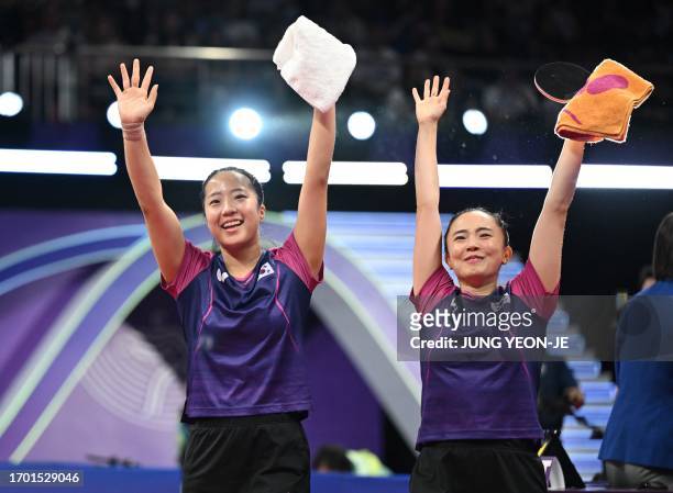 South Korea's Jeon Ji-hee and Shin Yu-bin celebrate their victory after defeating North Korea's Cha Su Yong and Pak Su Gyong in the women's doubles...