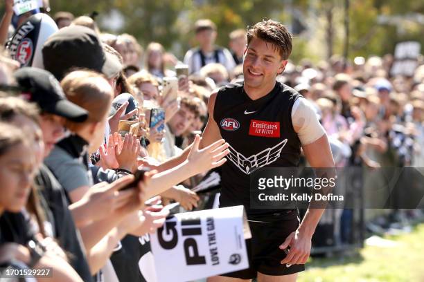 Patrick Linpinski of the Magpies greets fans during a Collingwood Magpies AFL training session at AIA Centre on September 26, 2023 in Melbourne,...