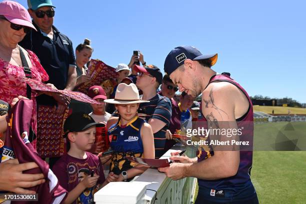 Lachie Neale of the Lions interacts with fans during a Brisbane Lions AFL training session at Brighton Homes Arena on September 26, 2023 in Ipswich,...