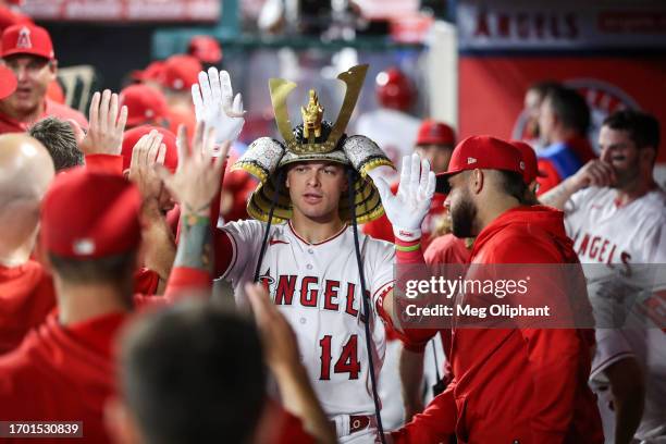 Logan O'Hoppe of the Los Angeles Angels celebrates in the dugout after hitting a solo home run in the second inning against the Texas Rangers at...