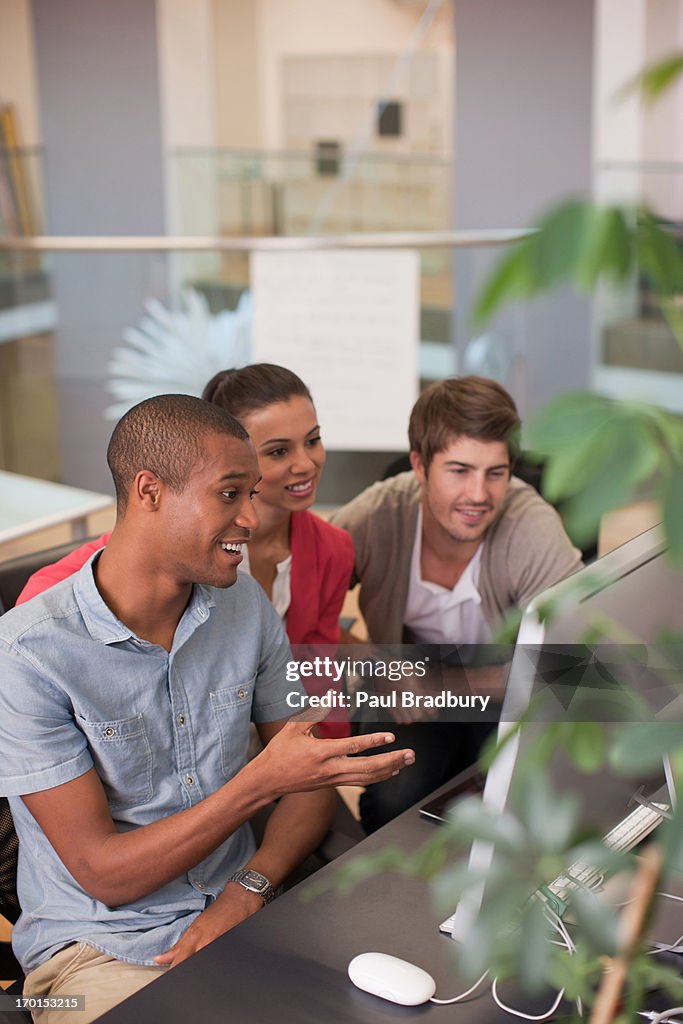 Business people using computer in office