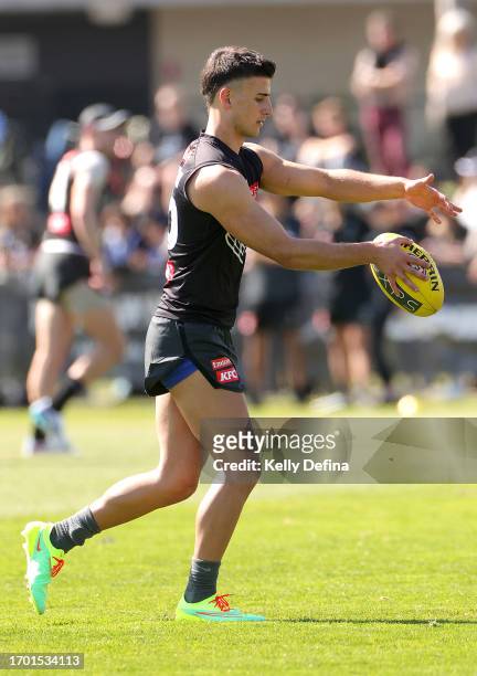 Nick Daicos of the Magpies kicks the ball during a Collingwood Magpies AFL training session at AIA Centre on September 26, 2023 in Melbourne,...