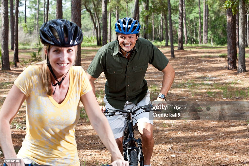 Mature couple riding bicycles