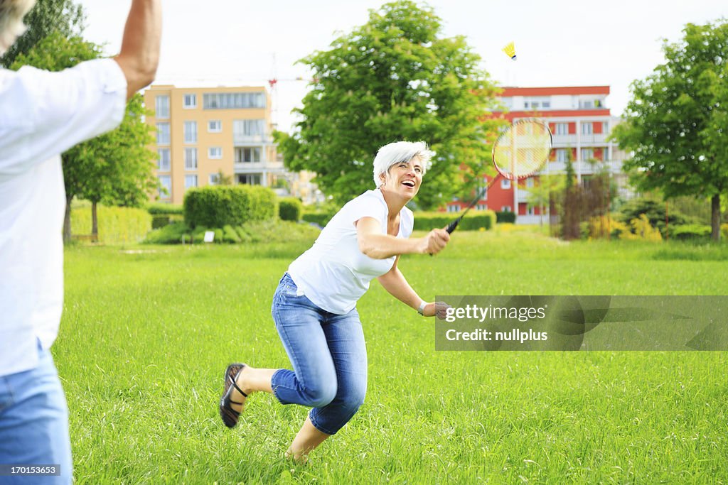 Senior couple playing badminton