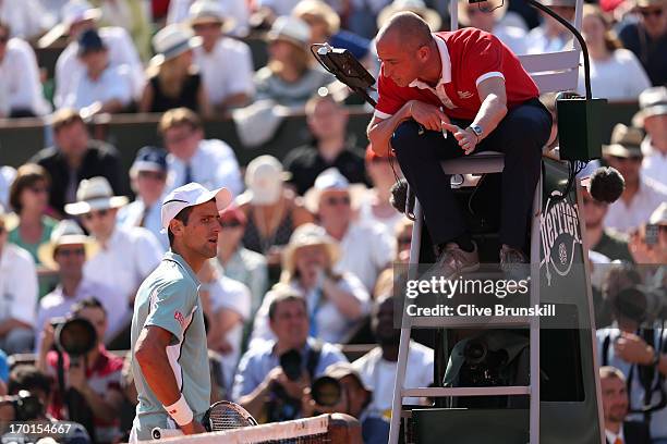 Novak Djokovic of Serbia appeals to the chair umpire Pascal Maria during the men's singles semi-final match against Rafael Nadal of Spain on day...