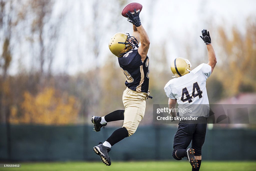 American football player catching a ball.