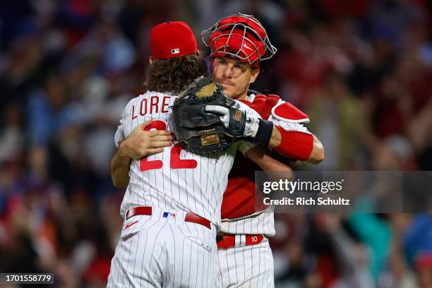 Relief pitcher Michael Lorenzen of the Philadelphia Phillies and catcher J.T. Realmuto embrace after defeating the New York Mets 5-2 in a game at...