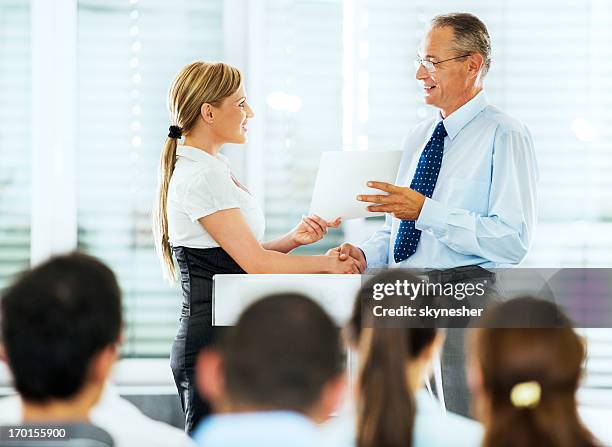 businesswoman receiving an award. - corporate awards ceremony stock pictures, royalty-free photos & images