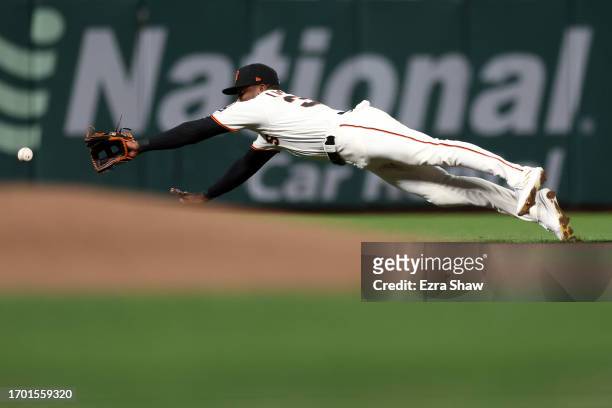 Marco Luciano of the San Francisco Giants can not stop a ball hit by Brett Sullivan of the San Diego Padres in the fifth inning at Oracle Park on...
