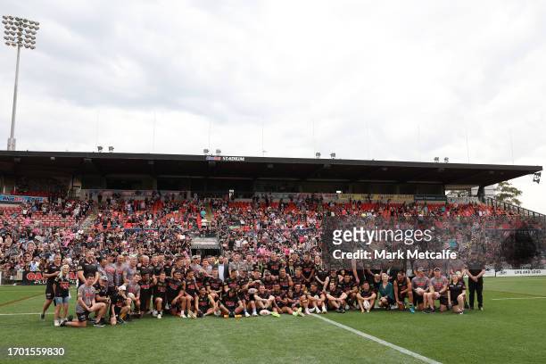 Panthers players and staff pose for a photo in front of fans during a Penrith Panthers NRL training session at BlueBet Stadium on September 26, 2023...