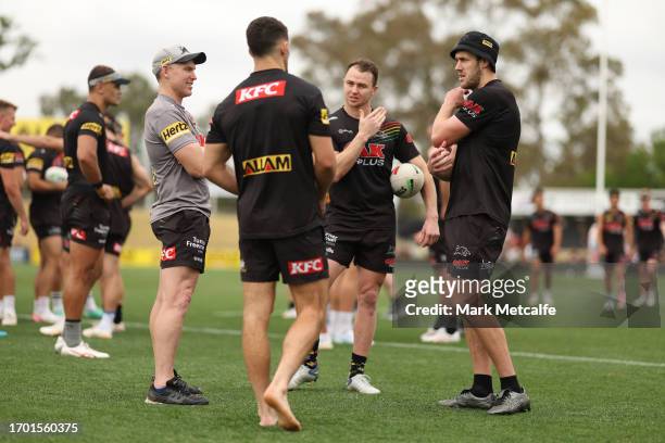 Isaah Yeo of the Panthers talks to team mates Dylan Edwards and Nathan Cleary during a Penrith Panthers NRL training session at BlueBet Stadium on...