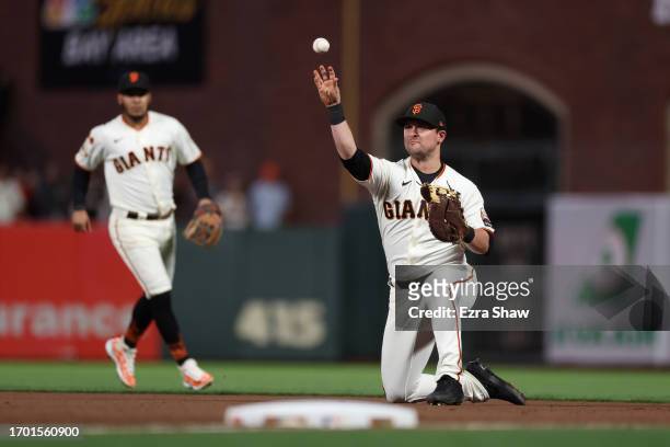 Davis of the San Francisco Giants throws out Ji Man Choi of the San Diego Padres in the fourth inning at Oracle Park on September 25, 2023 in San...